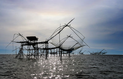 High angle view of large fishing net against cloudy sky