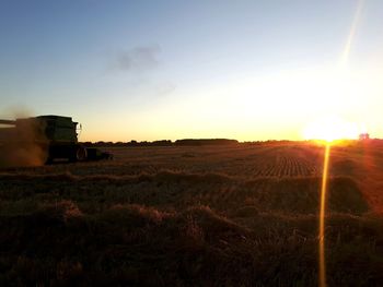 Scenic view of field against sky during sunset