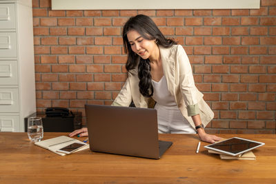 Woman using laptop on table