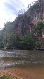 Scenic view of river and mountains against sky