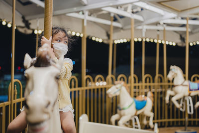 Rear view of woman sitting at amusement park