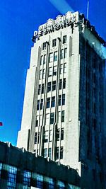 Low angle view of buildings against blue sky