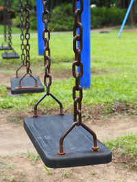 Close-up of empty swing in park