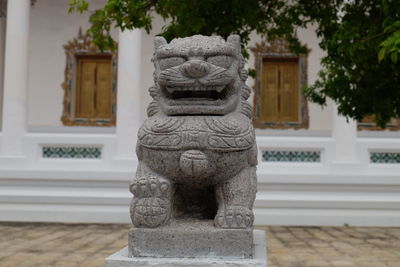 Statue outside temple against building