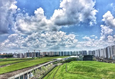 Scenic view of grassy field against cloudy sky