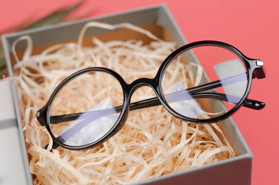 Close-up of eyeglasses on red background