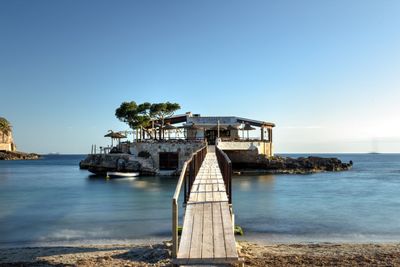 Scenic view of sea against clear blue sky