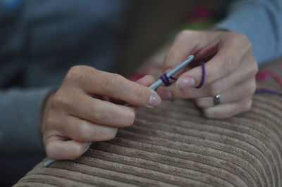 Cropped image of woman hands knitting wool