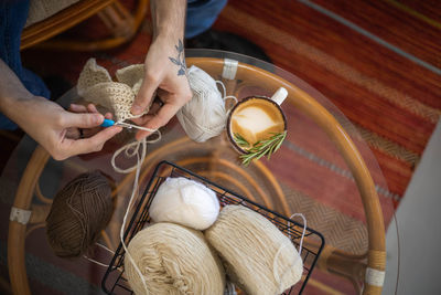 High angle view of hand holding rope