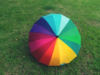 High angle view of multi colored umbrella on field
