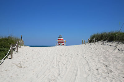 Lifeguard hut on beach against clear sky