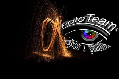 Close-up of illuminated lighting equipment against black background