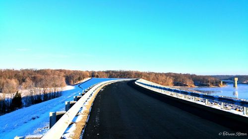 View of road against clear blue sky