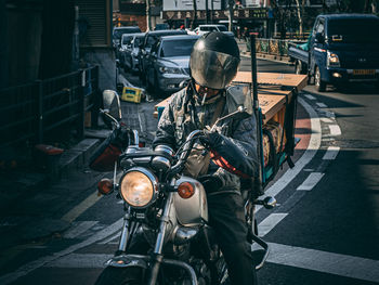 Man riding bicycle on city street