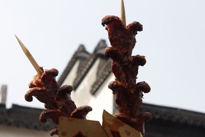 Low angle view of statue against sky