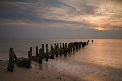 View of jetty at calm sea against the sky