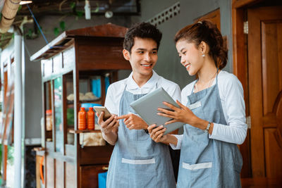 Portrait of young woman using mobile phone