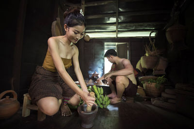 Young woman with man preparing food