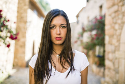 Portrait of beautiful young woman standing outdoors