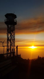 Scenic view of water tower against sky during sunset