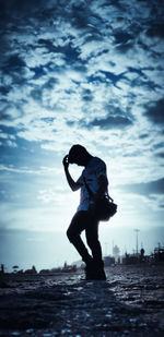 Full length of silhouette person on beach against sky during sunset