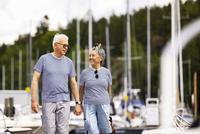 Senior couple walking in marina