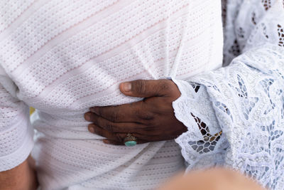 Midsection of woman holding hands