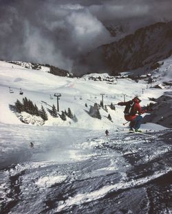 People skiing on snow covered landscape