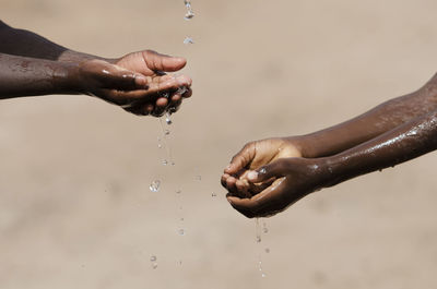 Cropped image of hand splashing water