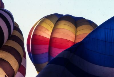 Low angle view of parachutes against clear sky