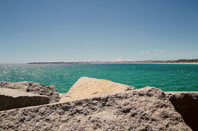 Scenic view of sea against clear blue sky