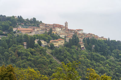 Buildings in town against sky