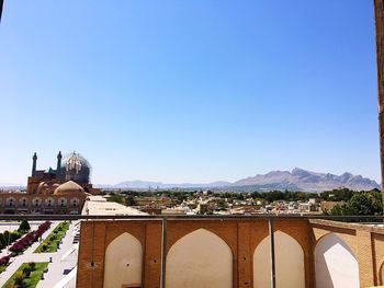 View of cityscape against blue sky