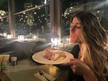 Portrait of woman with ice cream in restaurant