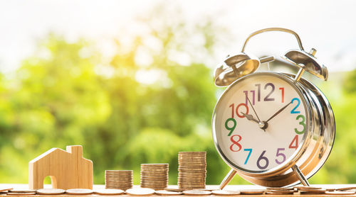 Close-up of clock on wooden table