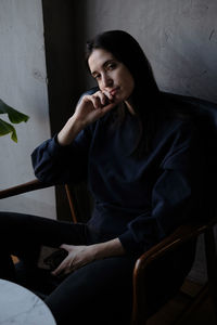 Young woman sitting on chair