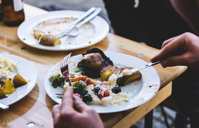 Midsection of person having food in plate