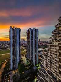 Buildings in city against sky during sunset