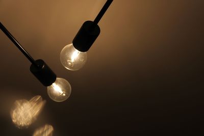 Close-up low angle view of illuminated light bulbs