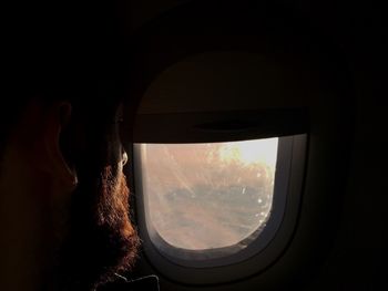 Airplane in sky seen through airplane window