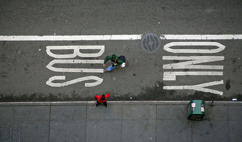 High angle view of people walking on road