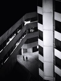 High angle view of people standing in passage of building