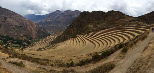 Panoramic view of agricultural field against sky