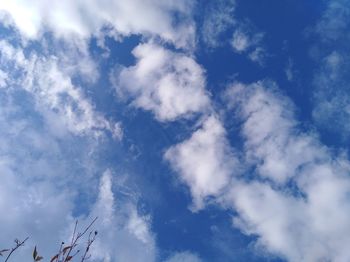 Low angle view of telephone pole against blue sky