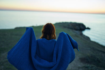 Rear view of woman looking at sea shore