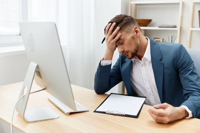 Side view of businesswoman working on table