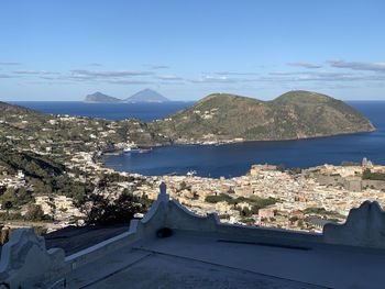 High angle view of buildings by sea