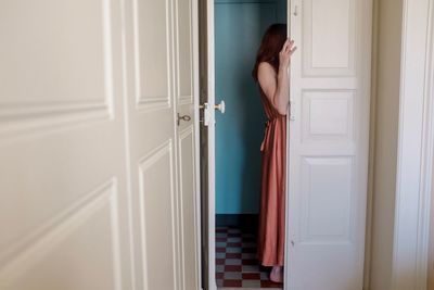 Rear view of woman standing at entrance