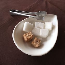 High angle view of sugar cubes in plate on table