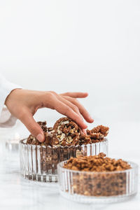 Midsection of person holding ice cream on table